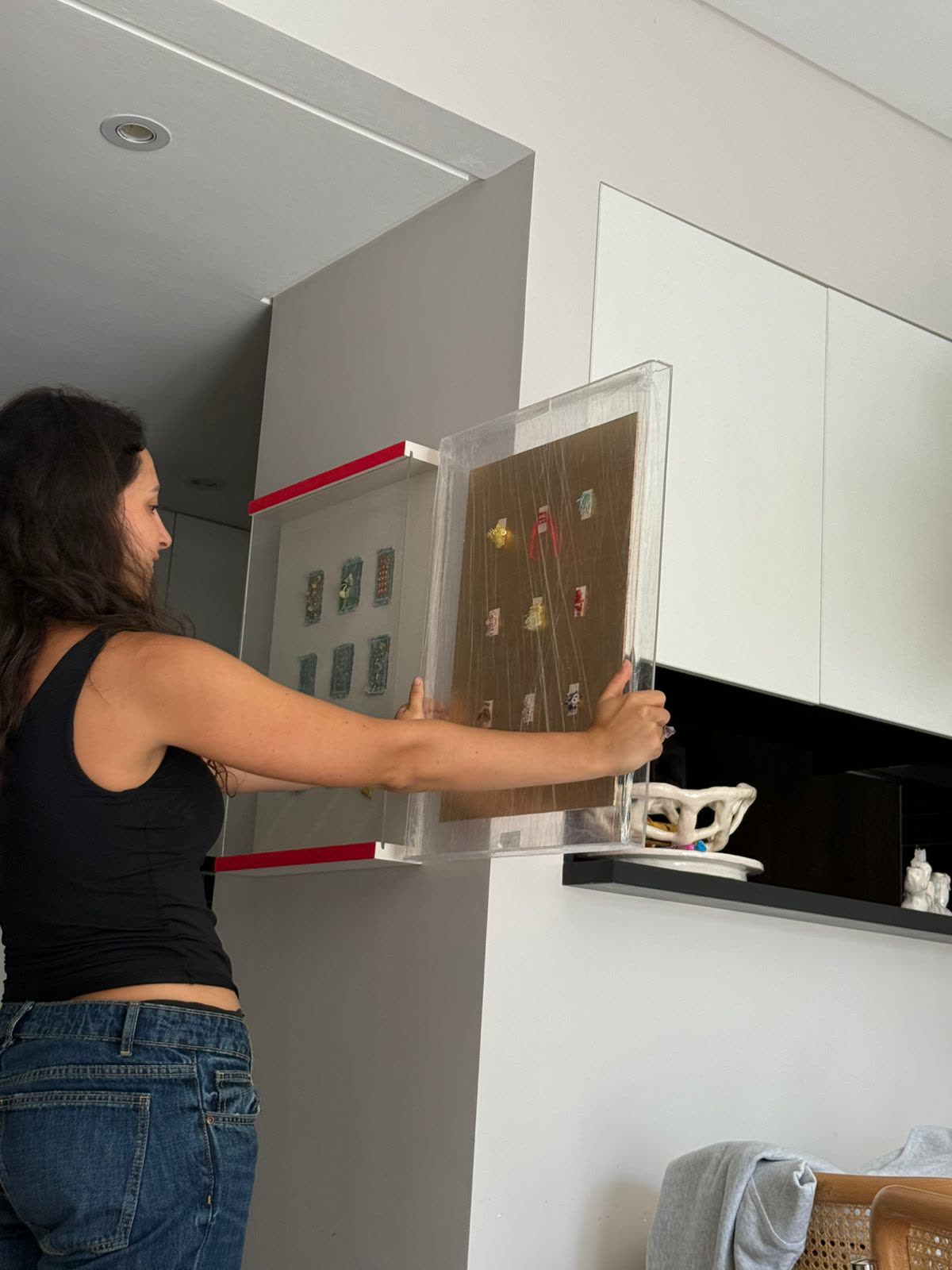 Camilla installing the acrylic box on the wall